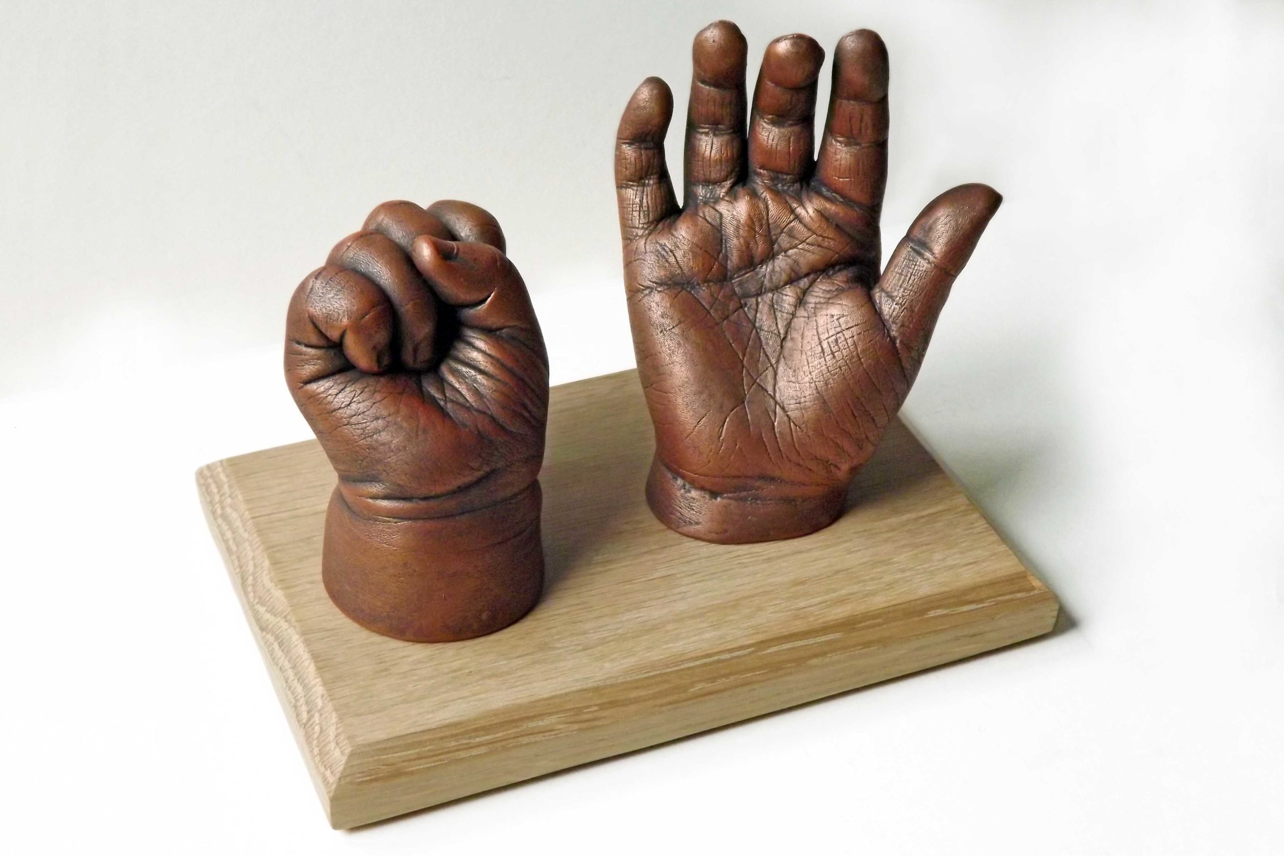 Sibling-casts-on-oak-plinth-med-baby-hand