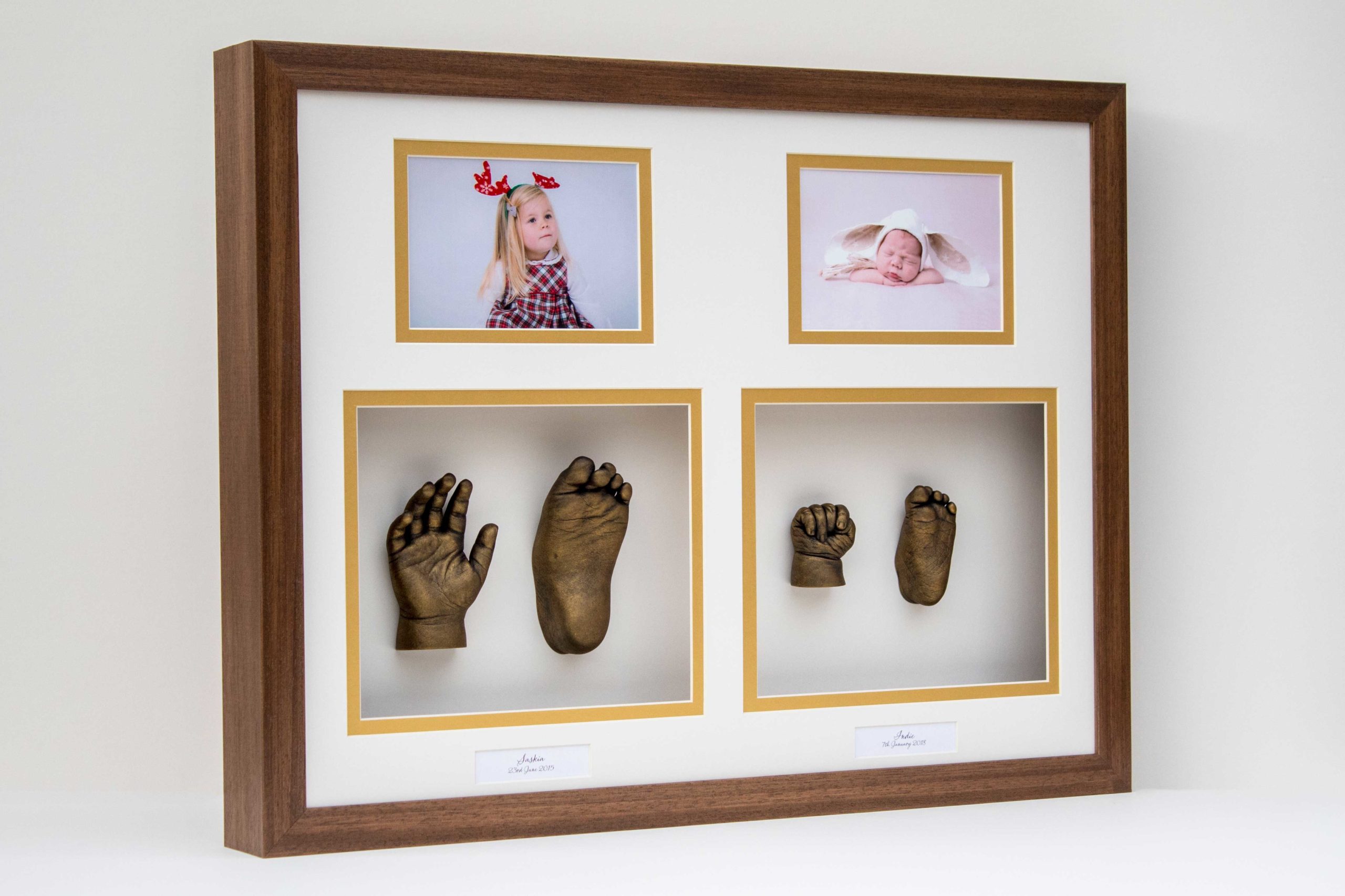 Sisters-framed-hand-foot-cast-gold-dark-wood-frame